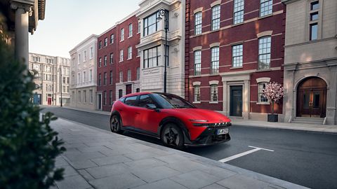 Red Hyundai IONIQ 3 N Line parked on a city street in front of attractive old buildings.