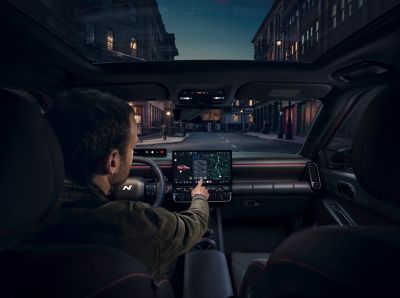 Man using the center touch screen inside the Hyundai IONIQ 3 N Line.
