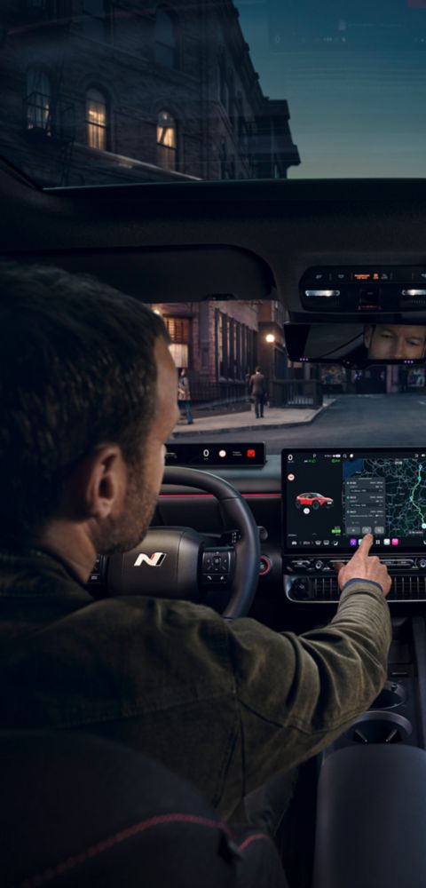 Man using the center touch screen inside the Hyundai IONIQ 3 N Line.