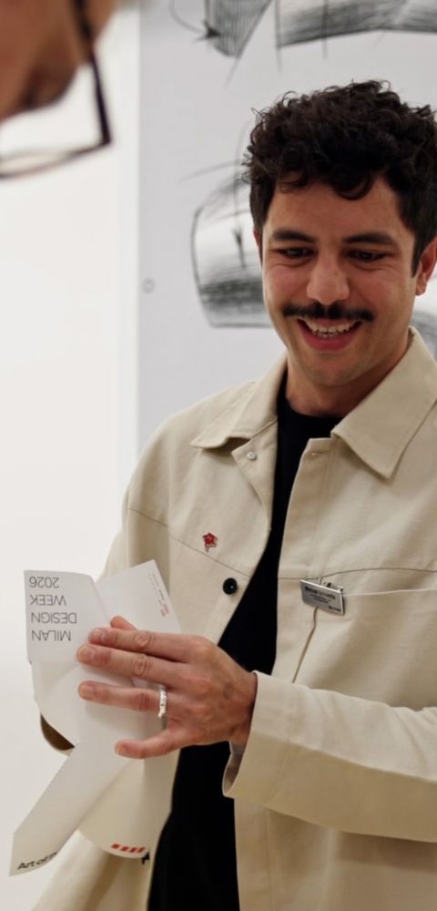 Visitor presenting printed material during Hyundai IONIQ 3 design workshop at Milan Design Week