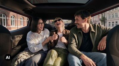 Spacious rear-seat interior of Hyundai IONIQ 3 with three passengers seated side by side.