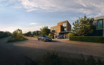Hyundai IONIQ 5 and IONIQ 6 parked in front of a modern single family home.