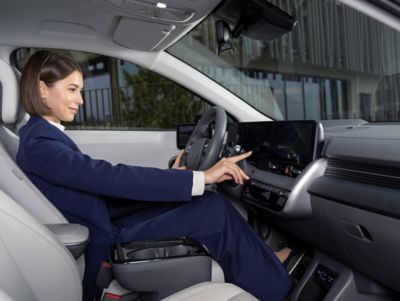 Person using the Hyundai IONIQ 5 infotainment system.