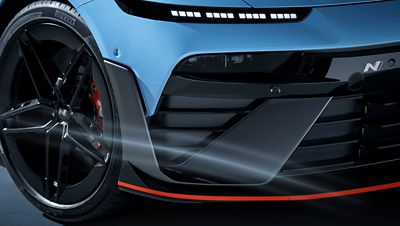 Close-up of Hyundai IONIQ 6N front wheel and aerodynamic bumper with performance detailing.