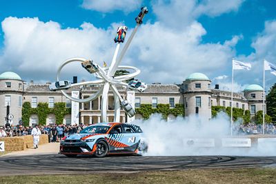 The Hyundai IONIQ 6 N drifting on a track with spectators in the background