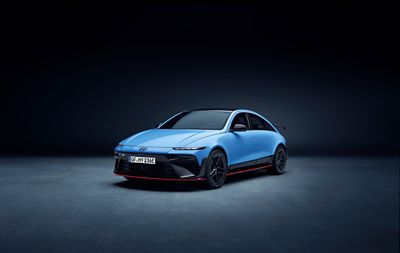 Front quarter view of Hyundai IONIQ 6N in studio setting, showcasing bold grille and sporty stance.