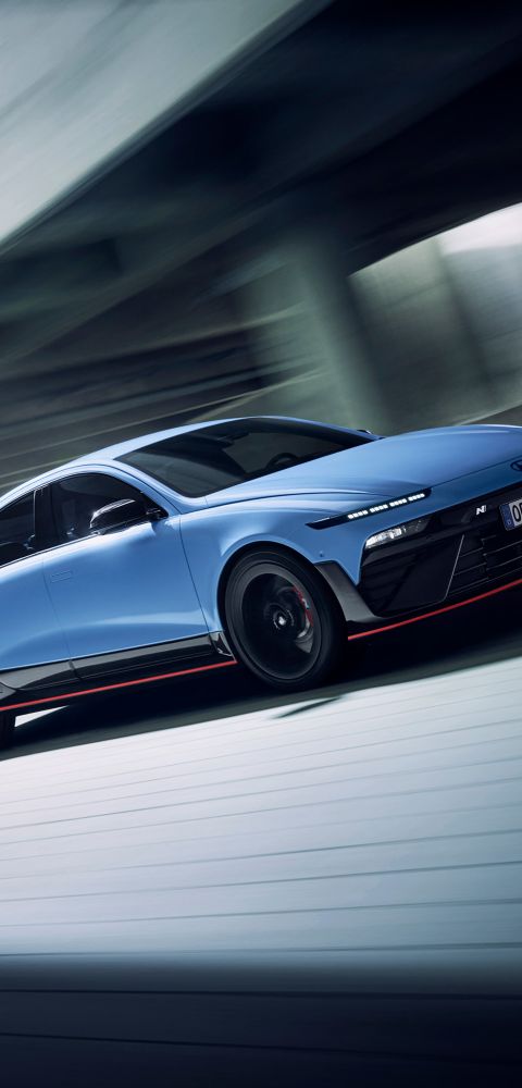 Hyundai IONIQ 6N driving through a modern structure, highlighting agility and performance.