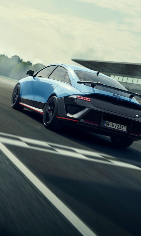 IONIQ 6 N racing on track, showcasing its sleek design and aerodynamic features in motion.