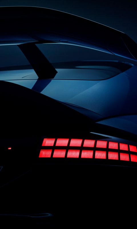 Close-up of Hyundai IONIQ 6N rear spoiler and illuminated tail lights highlighting sporty design.”