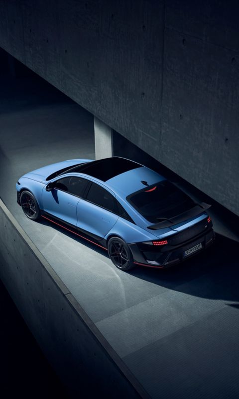 Top-down view of Hyundai IONIQ 6N on a curved ramp, highlighting streamlined roof and rear wing.