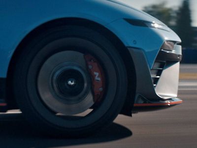 Close-up of the IONIQ 6 N's wheel, highlighting the brake caliper and wheel design in motion.