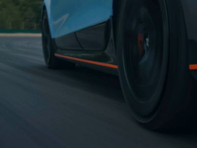 Detailed view of the IONIQ 6 N's side profile as it races along the track, emphasizing aerodynamic features.