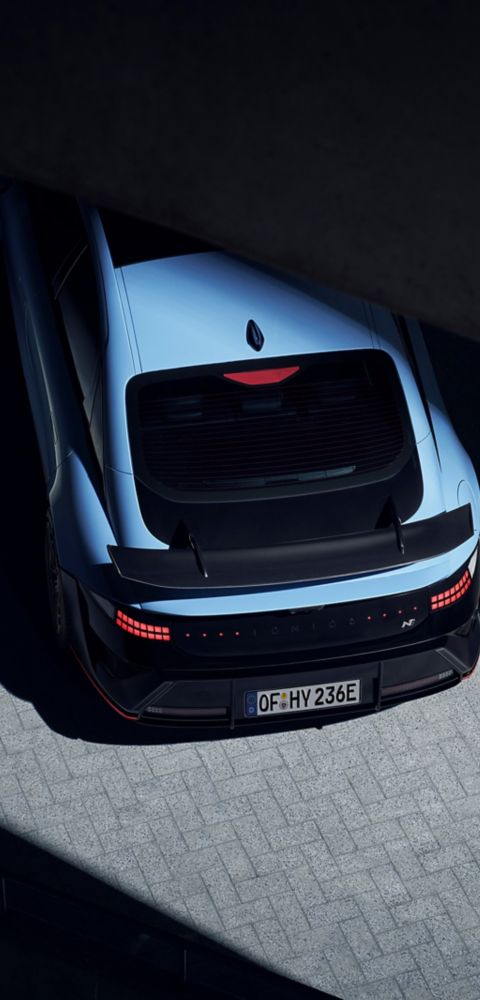 Top view of Hyundai IONIQ 6N under a bridge, emphasising rear wing and streamlined profile.