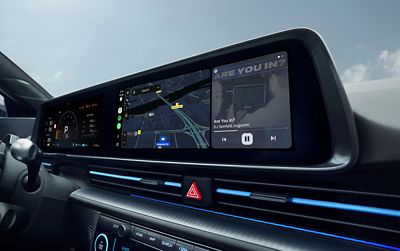 IONIQ 6 N dashboard with dual screens showing navigation map and music playback interface.