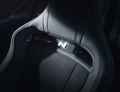 Close-up of the N logo on the sports bucket seat inside the Hyundai IONIQ 6 N.