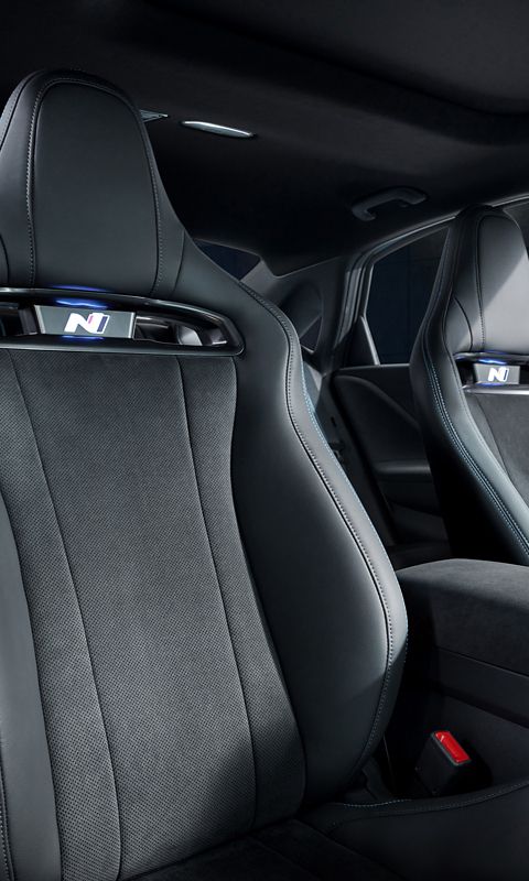 Interior view of sporty front seats in the Hyundai IONIQ 6 N, emphasizing comfort and style with detailed stitching.
