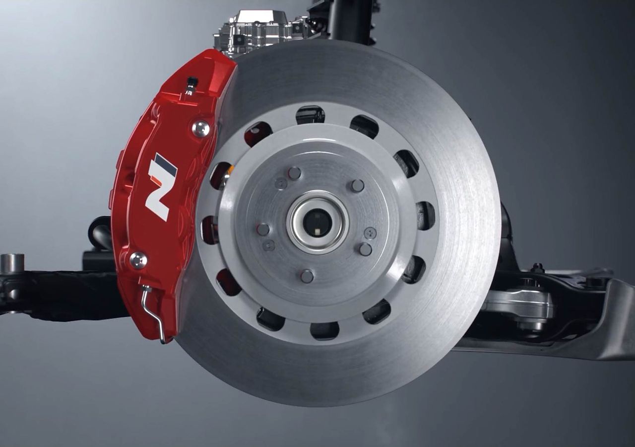 Close-up of a high-performance brake assembly on a Hyundai IONIQ 6 N showcasing detailed engineering.