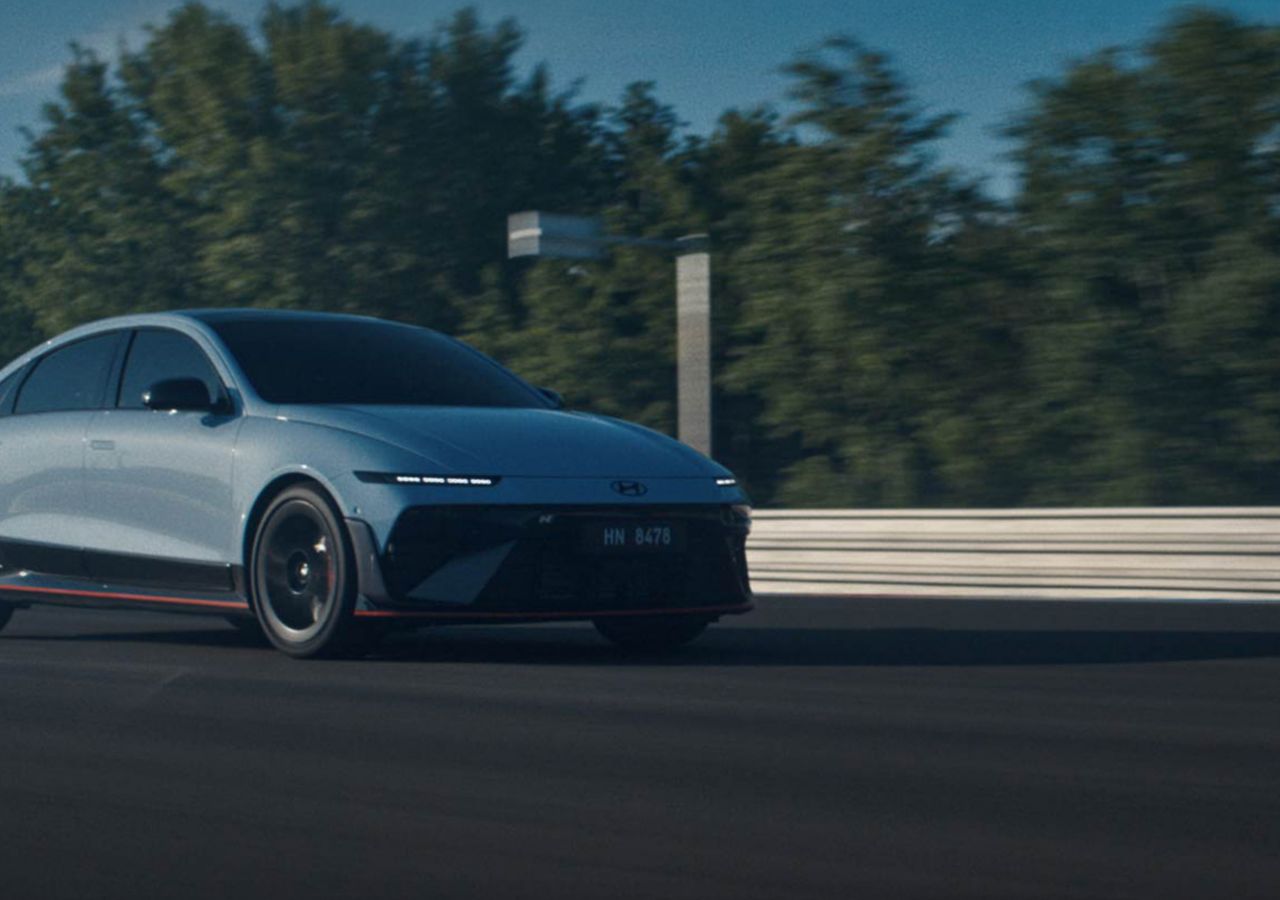 Action shot of the Hyundai IONIQ 6 N on a racetrack, capturing its sporty presence and speed in motion.