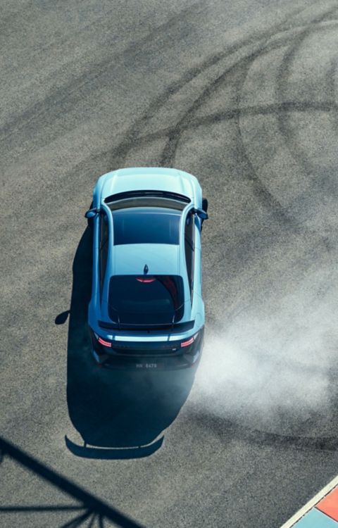 Top-down view of Hyundai IONIQ 6 N high-performance electric car drifting in tight donut loops on race track.