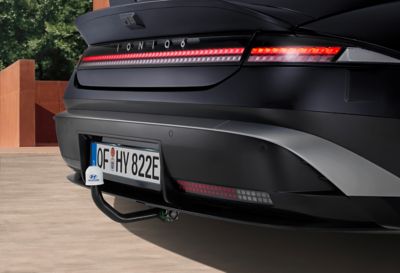 Hyundai IONIQ 6 with mounted tow bar detachable transport accessory.