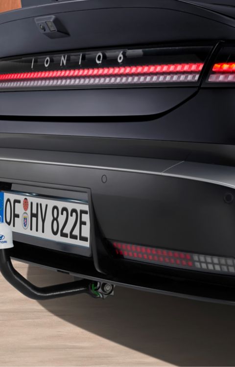 Hyundai IONIQ 6 with mounted tow bar detachable transport accessory.