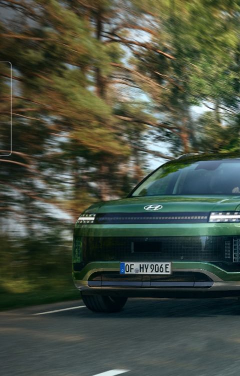 A Hyundai IONIQ 9 on a forest road with EURO NCAP badge showing 5-star rating.