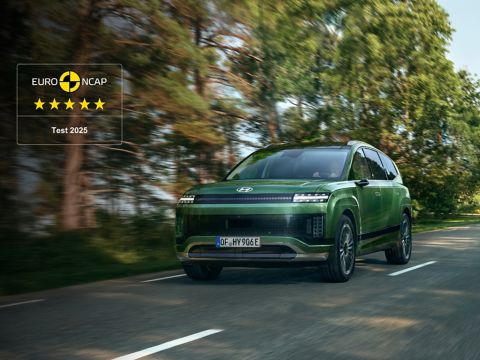 A Hyundai IONIQ 9 on a forest road with EURO NCAP badge showing 5-star rating.