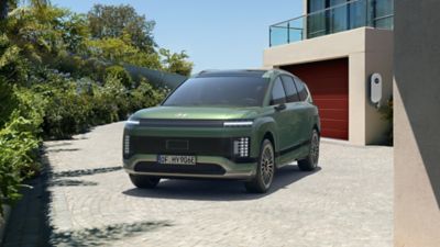  Hyundai IONIQ 9 electric SUV parked in front of a house.