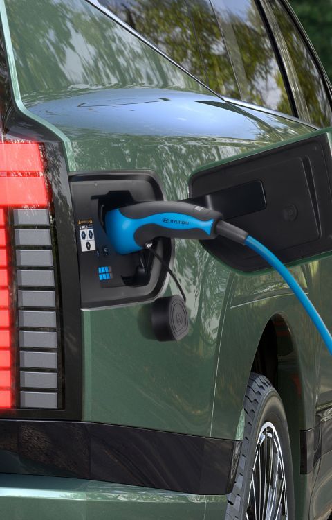 The open charging socket of Hyundai IONIQ 9 electric SUV with charging cable.