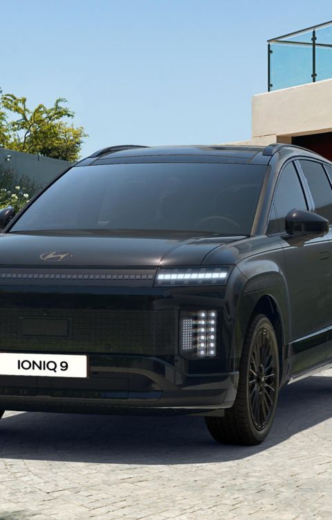 Hyundai IONIQ 9 electric SUV in Calligraphy Black Ink trim shown from the front and side.