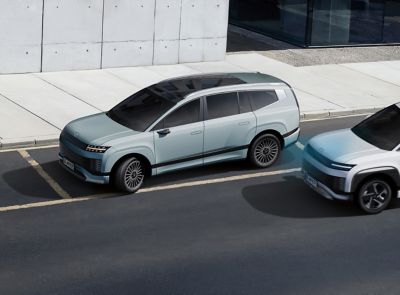 Hyundai IONIQ 9 parked beside a modern building.