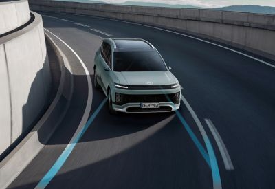 Hyundai IONIQ 9 driving on a curved road.