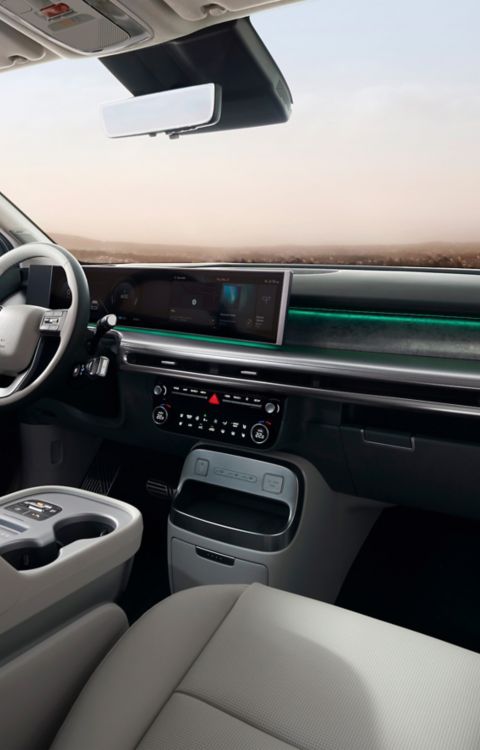 Interior of the Hyundai IONIQ 9 cockpit showing the integrated displays and both front seats.