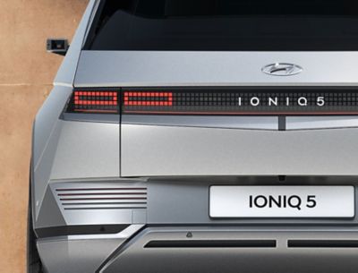 The Hyundai IONIQ 5 electric midsize CUV showing of its backlights and futuristic design.