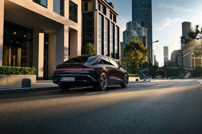 Hyundai IONIQ 6 electric sedan shown from the rear and side parked on a city street.