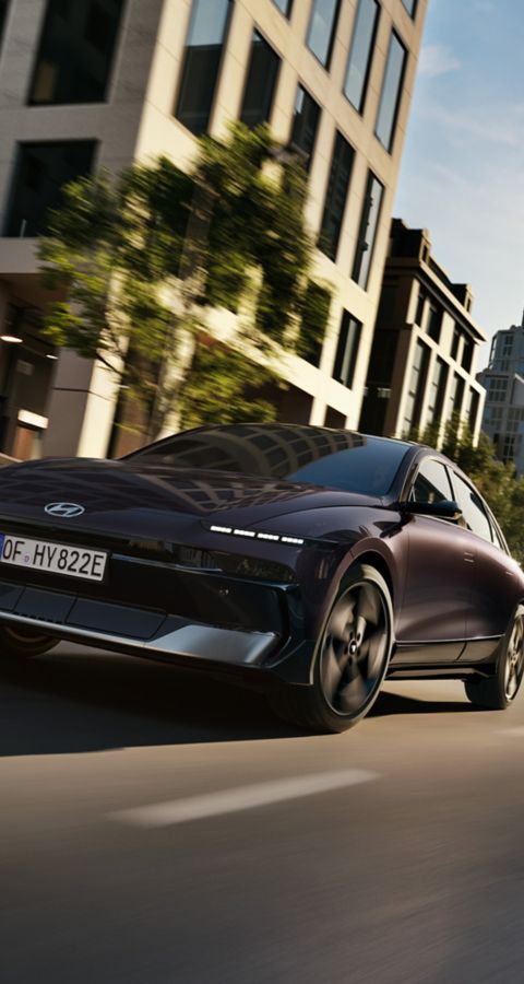 Hyundai IONIQ 6 driving on a city street.