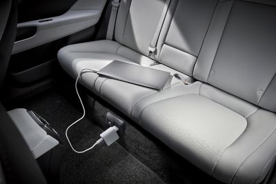  Laptop plugged into the on-board 230V socket of Hyundai IONIQ 6’s Vehicle-to-Load technology.