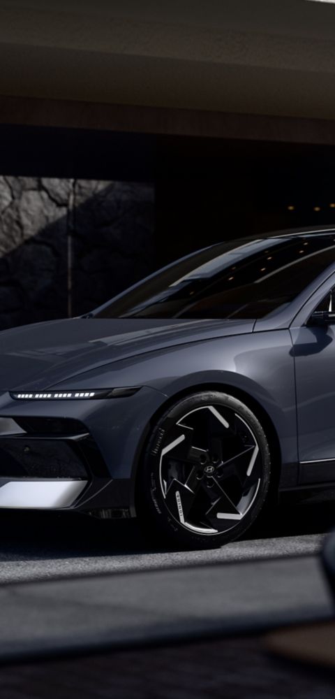 The Hyundai IONIQ 6 electric sedan parked in front of a modern building.