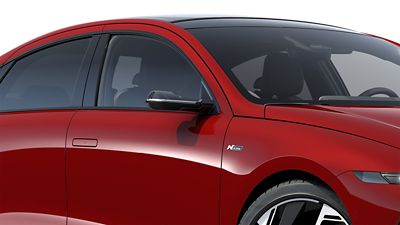 Glossy black mirror caps on a red Hyundai IONIQ 6 N Line electric sedan.