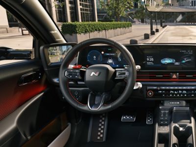 Leather N Line steering wheel inside a Hyundai IONIQ 6 N Line electric sedan.	
