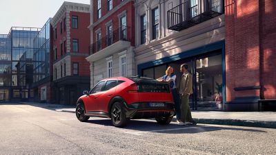 Hyundai IONIQ 3 parked on a city street outside a residential building.