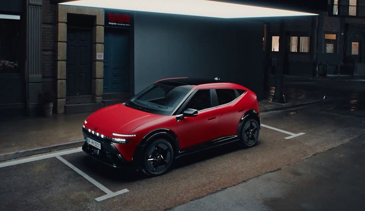 Hyundai IONIQ 3 N Line in red shown from the side, parked on a city street.