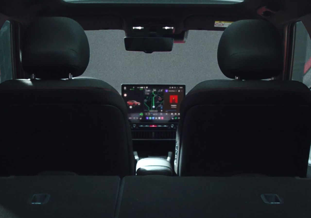 	 A rear interior view inside Hyundai IONIQ 3 looking toward the front cabin.