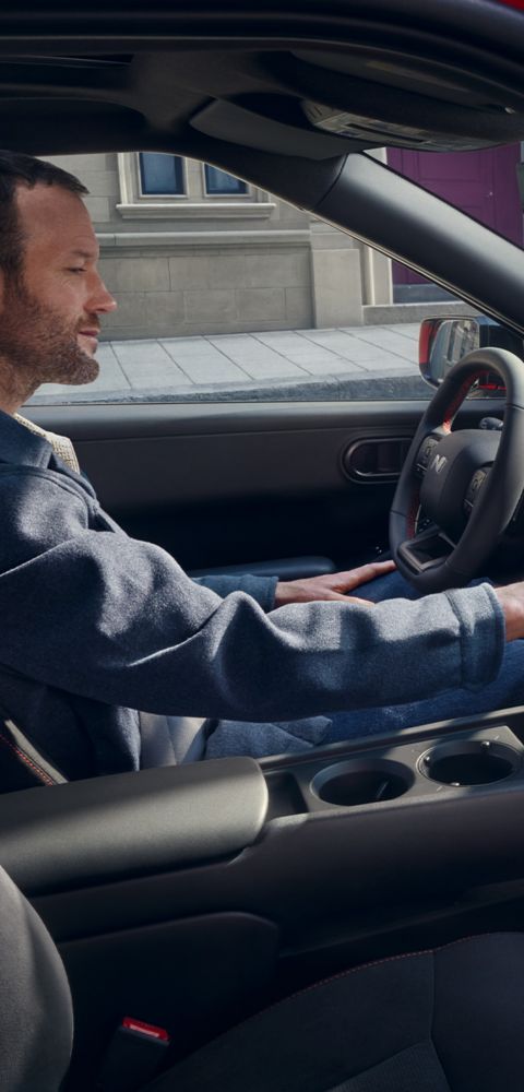  A man in the driver's seat interacting with the touchscreen display of Hyundai IONIQ 3
