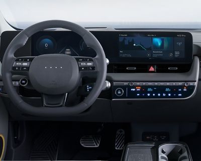 The steering wheel and integrated displays on the dashboard of the Hyundai IONIQ 5.