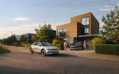 Hyundai IONIQ 5 and IONIQ 6 parked in front of a modern single family home.