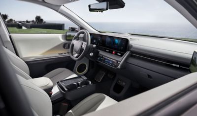 Interior of new Hyundai IONIQ 5 cockpit showing the steering wheel, dashboard and touchscreen.