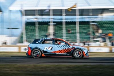  An Hyundai i20 N in Performance Blue with racing stickers on the track