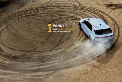 The all-electric Hyundai IONIQ 5 N drifting in circles on a dirt ground.