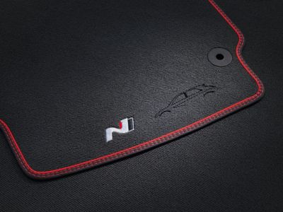 Image of the floor mat with the performance red stitching and the n logo